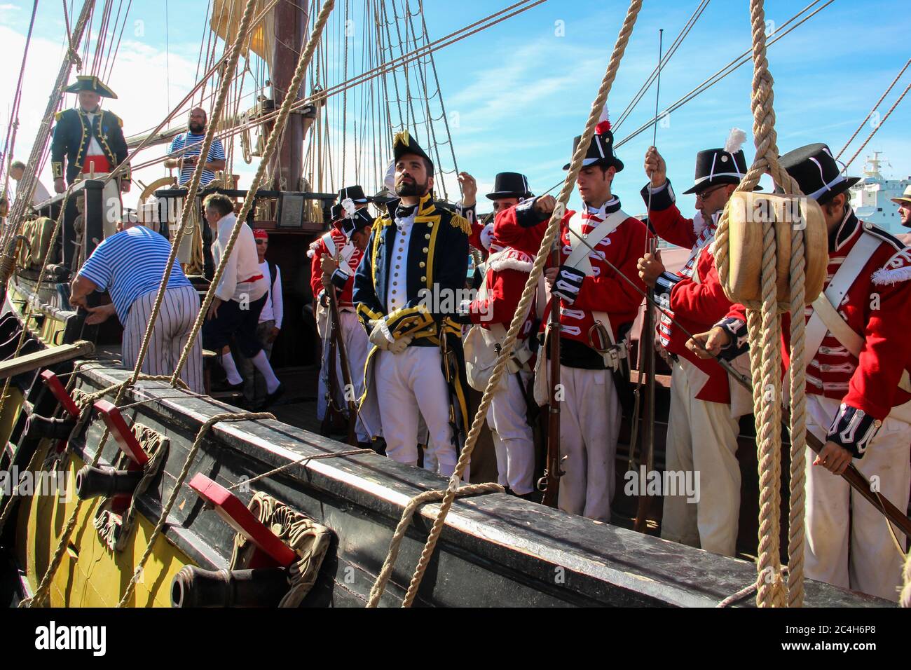 Malaga, Spain - October 26, 2014: Captain of the Royal Navy in the 18th century on a ship with his crew of marines and seamen. Reenactors on a brig wi Stock Photo