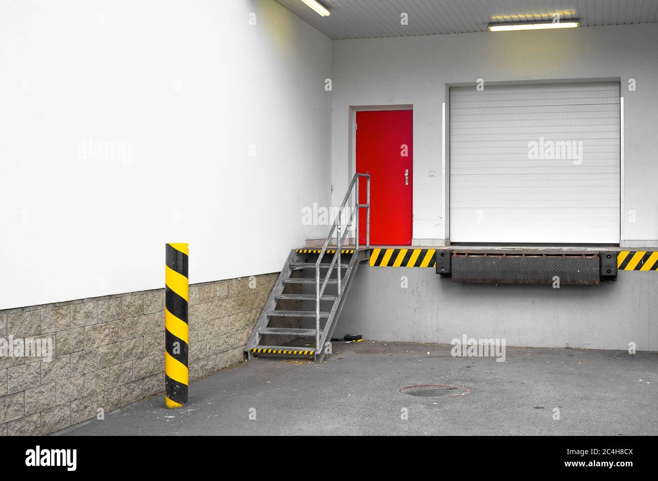 Loading dock for loading and unloading of goods, merchandise, item, article and commodity from truck and lorry to storehouse and warehouse. Stock Photo