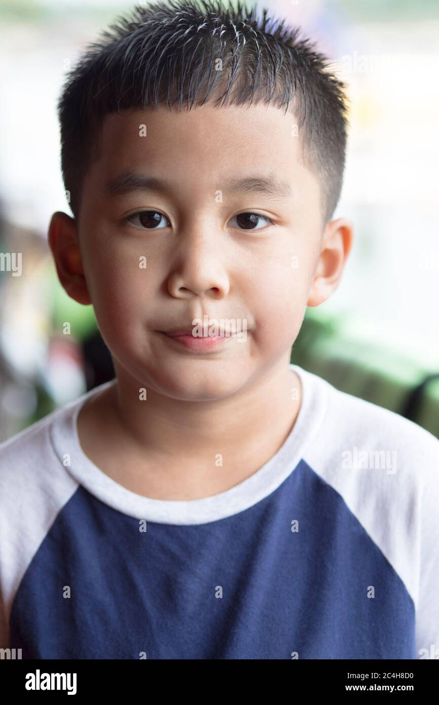 headshot of asian boy looking with eye contact to camera Stock Photo