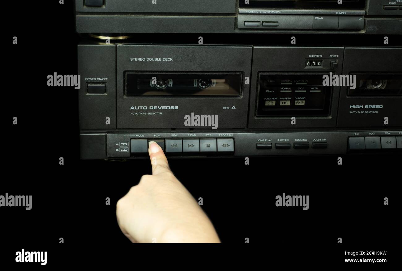 Hand push buttons stereo cassette tape player are retro technology Stock Photo