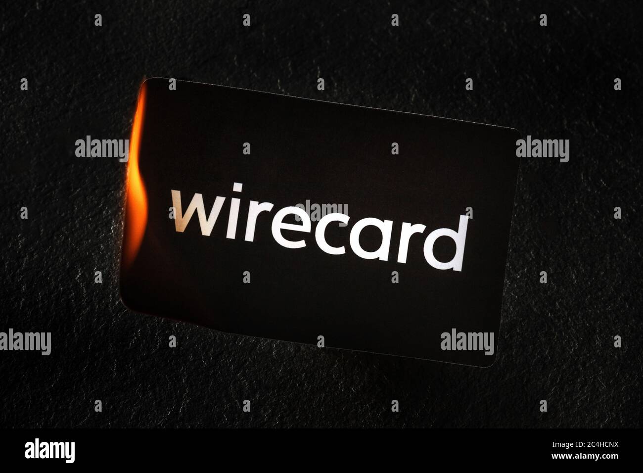 Madrid, Spain - June 27, 2020: Wirecard prepaid card burning on fire following the company bankruptcy and the freezing of cardholders' money Stock Photo
