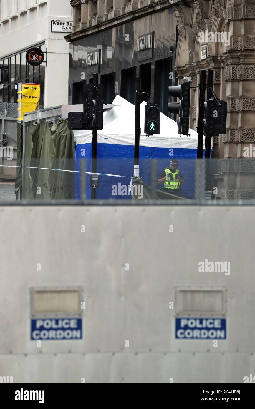 Police at the scene in West George Street, Glasgow, where a man was shot by an armed officers after another police officer was injured during an attack on Friday. Stock Photo