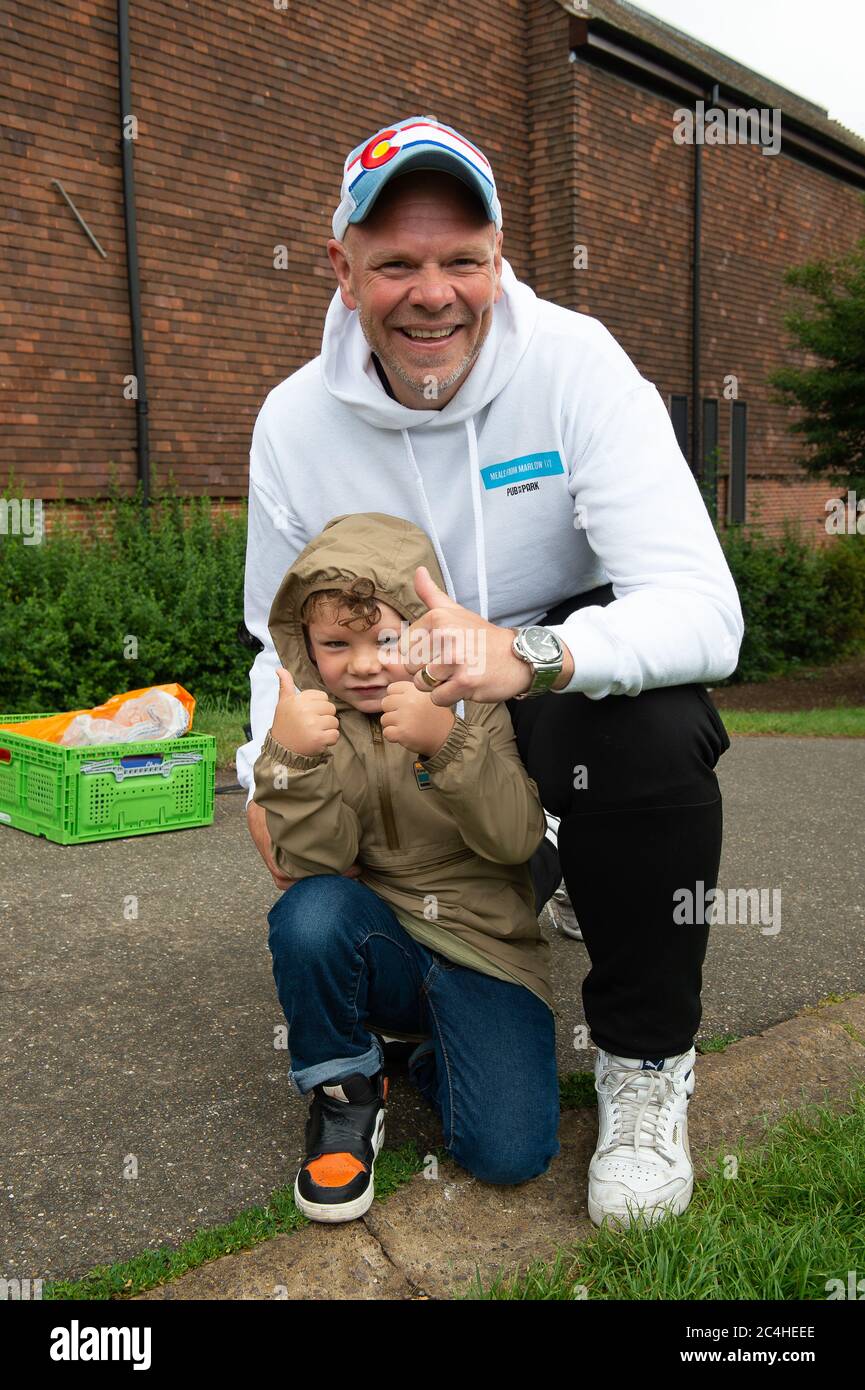 Marlow, Buckinghamshire, UK. 27th June, 2020. Celebrity Chef Tom Kerridge, his furloughed chefs and volunteers from Meals from Marlow have been cooking and delivering free meals to NHS key workers, people self isolating and those in need during the Coronavirus lockdown. Today 75,000th meal was delivered to Joyce aged 90 who lives in Marlow. Pictured Tom and his son Acey aged 4. Credit: Maureen McLean/Alamy Live News Stock Photo