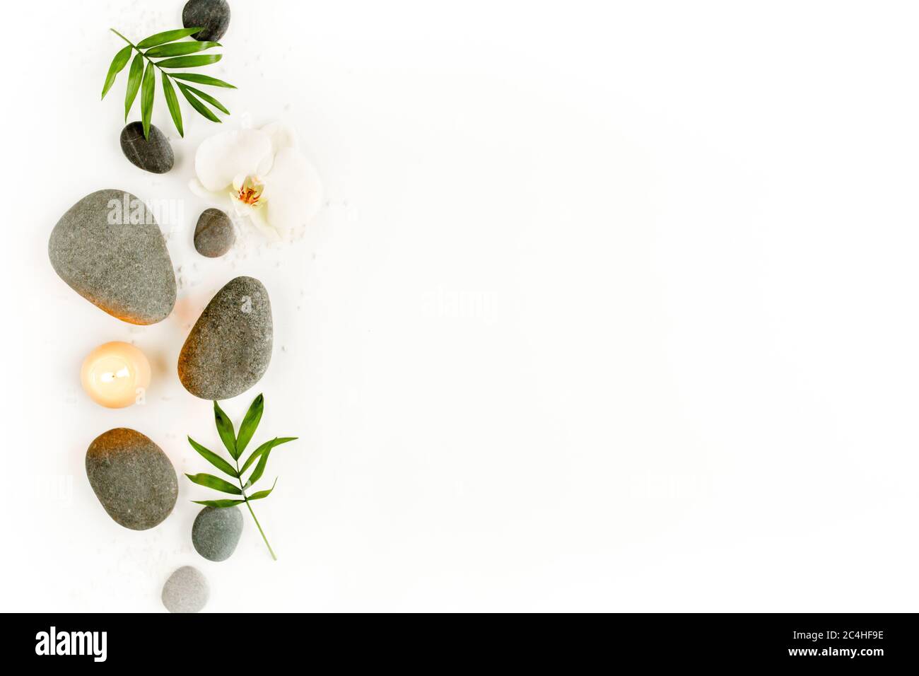 Spa stones, palm leaves, flower white orchid, candle and zen like grey ...