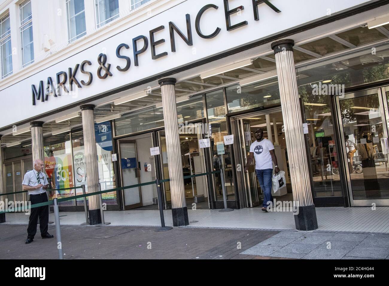 London, UK. 27th June 2020. A shopper leaves a Marks & Spencer department store on Kingston Upon Thames high street as shoppers slowly return to the high streets ahead of thousands reopening on July 4 as lockdown restrictions are further eased across England. June 26th 2020, Kingston Upon Thames, Southwest London, England, United KIngdom Credit: Clickpics/Alamy Live News Stock Photo