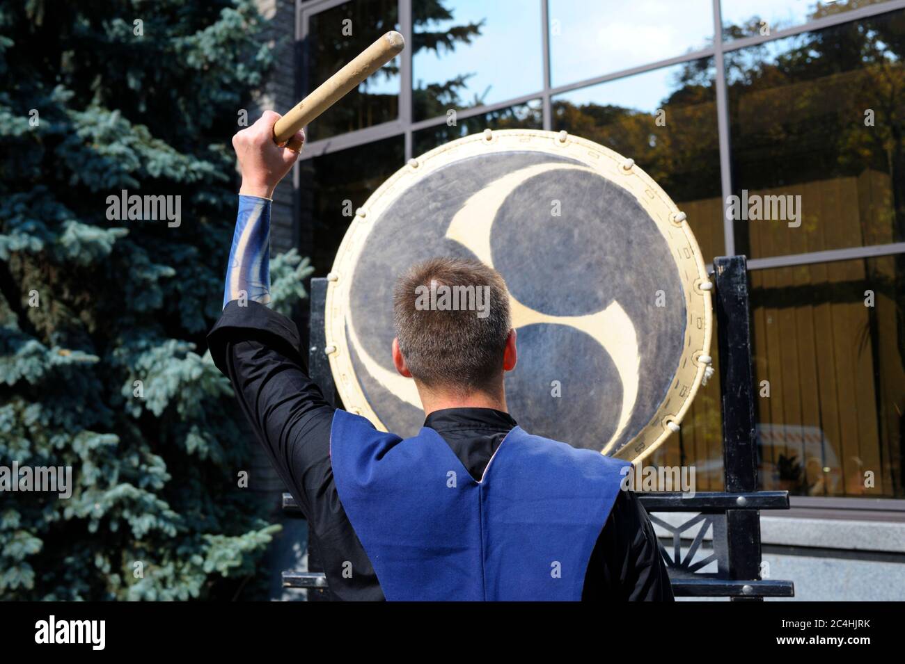 Man holding drumstick playing Japan a musical instrument taiko Stock