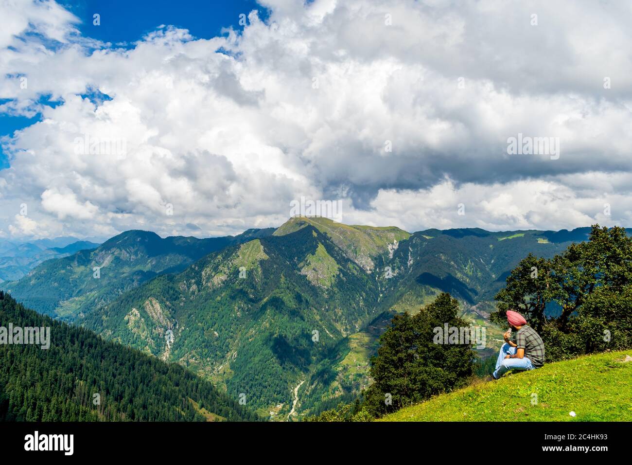 Jalori Pass, Himachal Pradesh, India; 20-September-2019; a solo trekker enjoying the mountain view, Jalori Pass, Himachal Pradesh, India Stock Photo