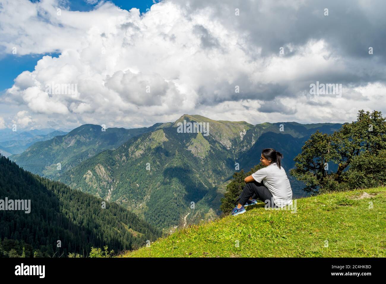 Jalori Pass, Himachal Pradesh, India; 20-September-2019; a solo woman trekker enjoying the mountain view, Jalori Pass, Himachal Pradesh, India Stock Photo