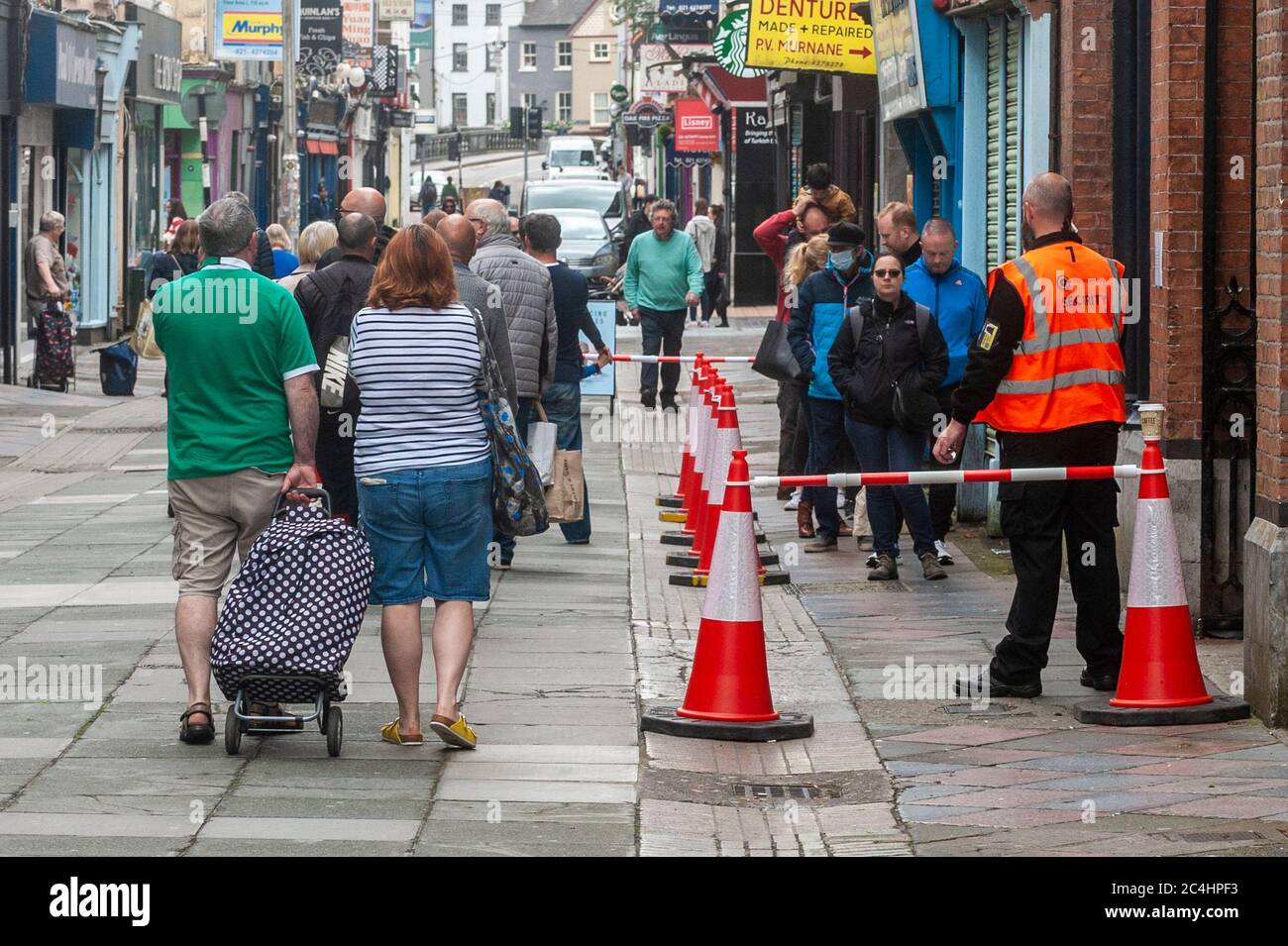 Cork, Ireland. 27th June, 2020. Cork City was busy with shoppers today, as things get back to a new normal after the Coronavirus lockdown. There was a big queue to get into the world famous English Market in Cork City. Credit: AG News/Alamy Live News Stock Photo