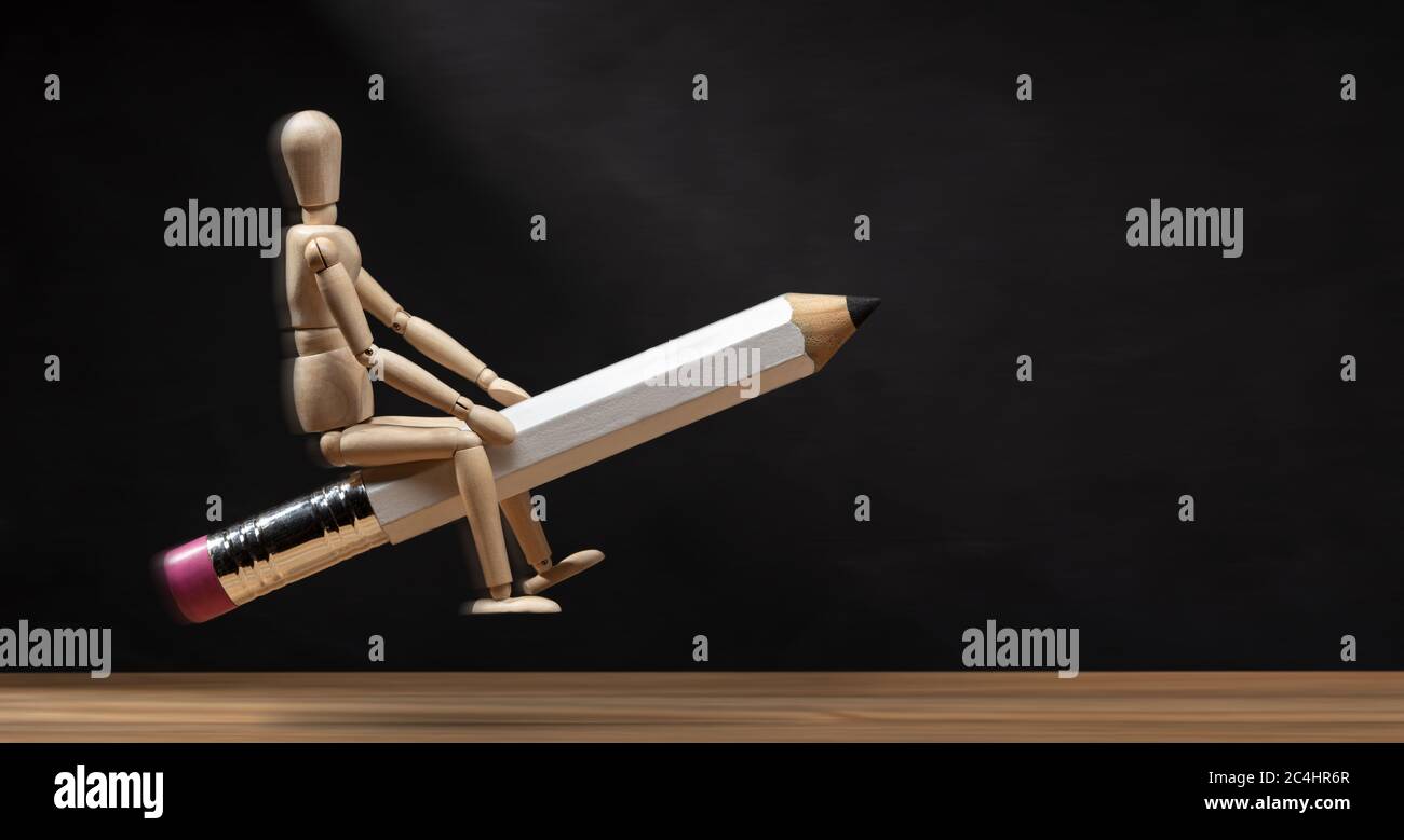 Wooden mannequin riding a pencil like a rocket. Banner Back to school concept. Copy space Stock Photo