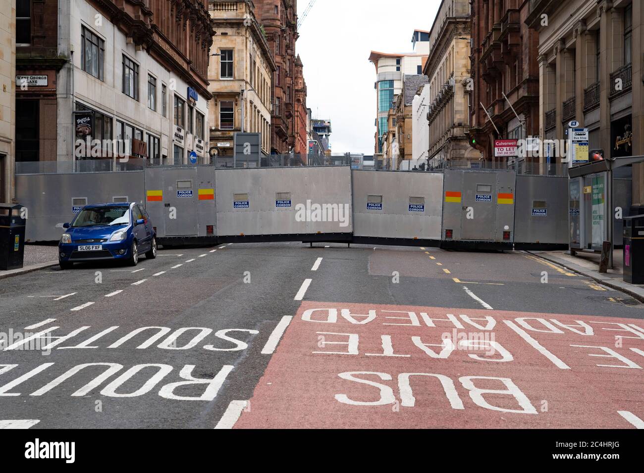 Glasgow, Scotland, UK. 27 June, 2020. Police cordon off city centre street with large steel barrier following stabbing and fatal shooting at Ibis hotel on West George Street yesterday.  Iain Masterton/Alamy Live News Stock Photo