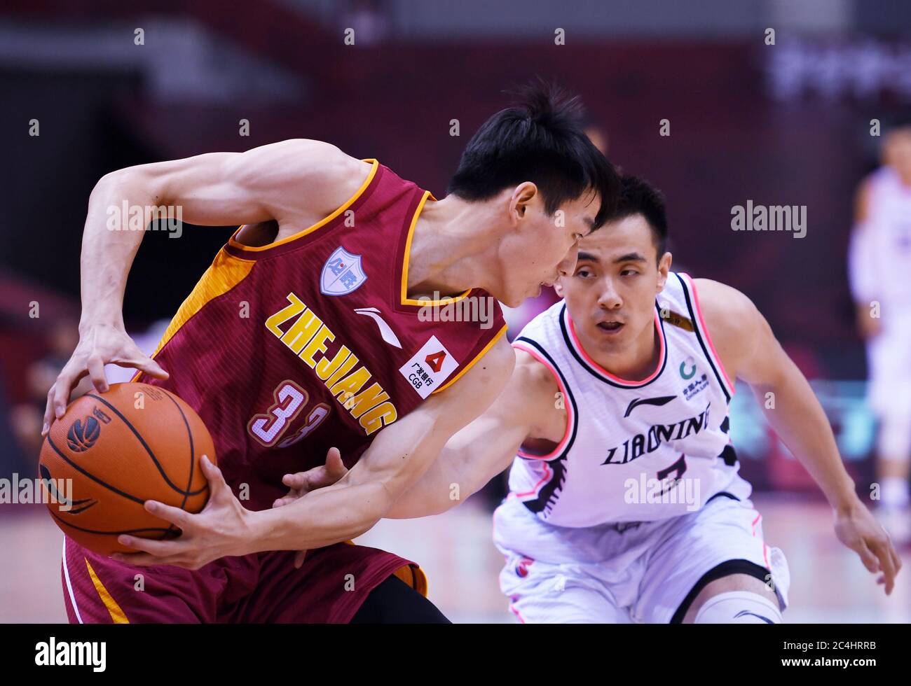 Qingdao, China's Shandong Province. 27th June, 2020. Wu Qian (L) Zhejiang Golden  Bulls tries to pass the ball during a match between Zhejiang Golden Bulls  and Liaoning Flying Leopards at the newly