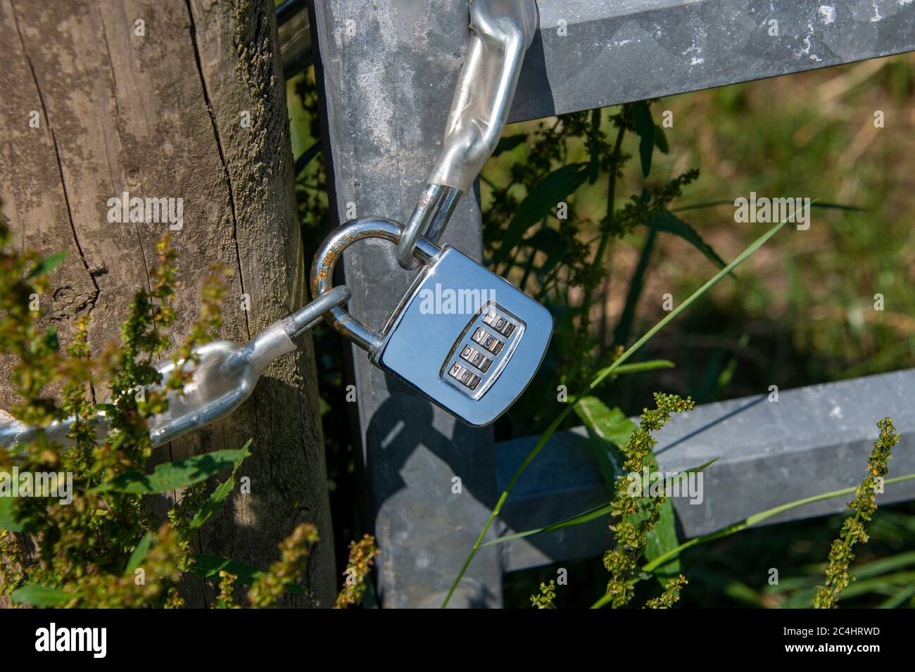 steel combination padlock on a gate ouside Stock Photo Alamy