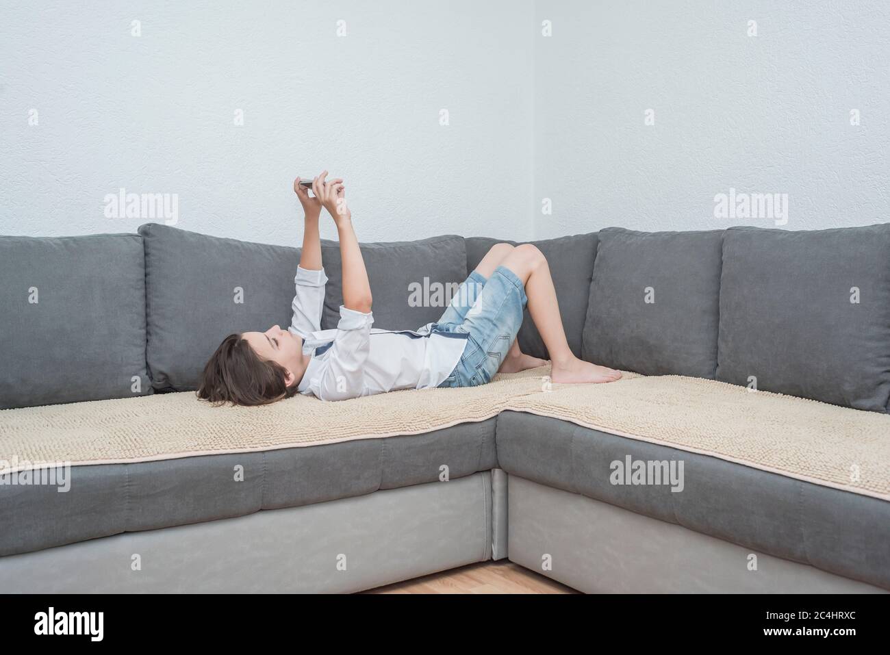 boy in a room with a laptop and a smartphone Stock Photo - Alamy