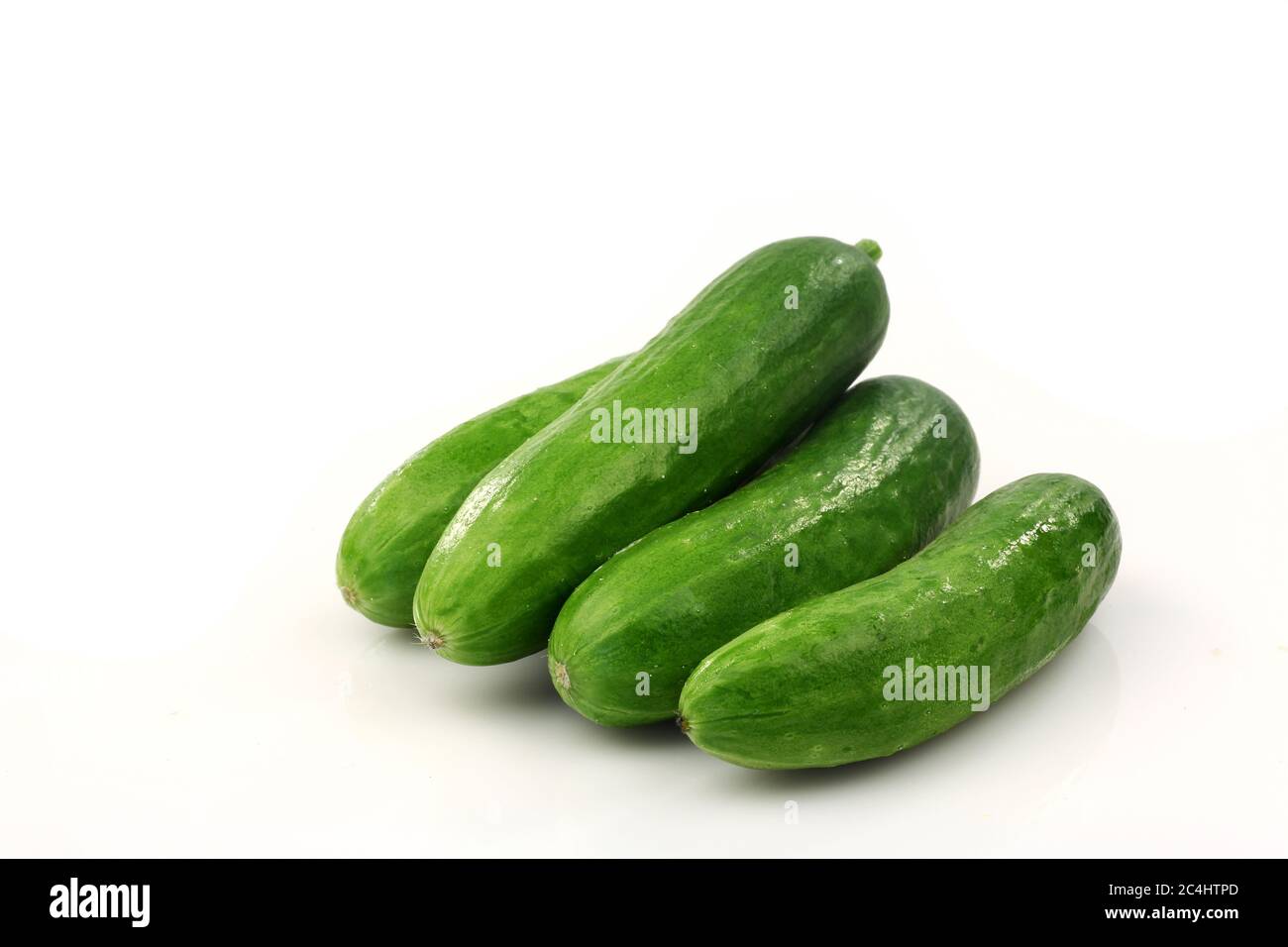 fresh green cut baby cucumbers you can eat as a snack on a white