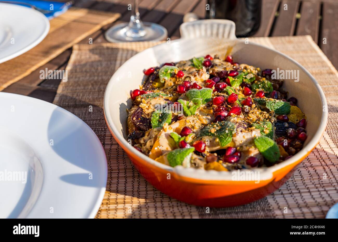 Middle Eastern roasted vegetable dish with lentils, butternut squash and pomegranate seeds, Summer meal outdoors, UK Stock Photo