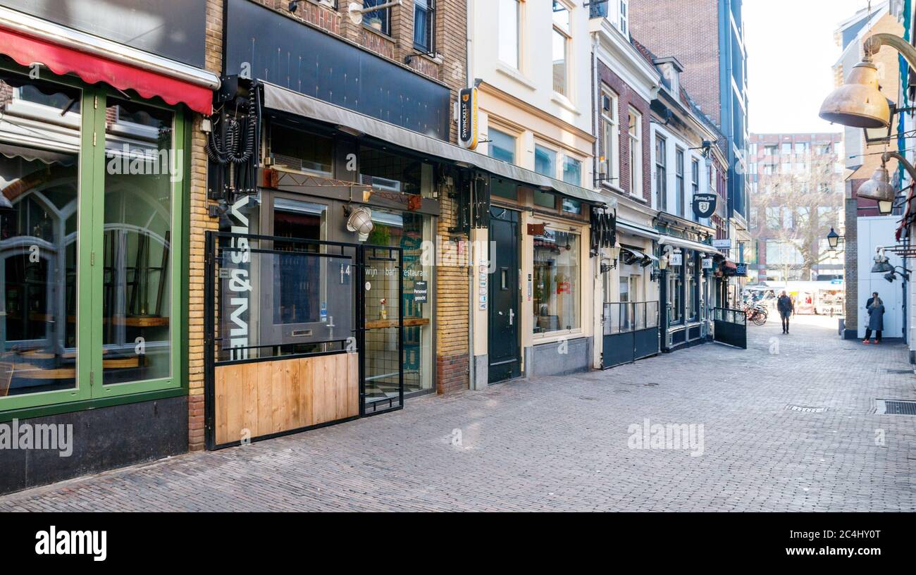 Bars and restaurants at a desolate Drieharingstraat. All bars and restaurants are closed due to the COVID-19 pandemic. Utrecht, The Netherlands. Stock Photo
