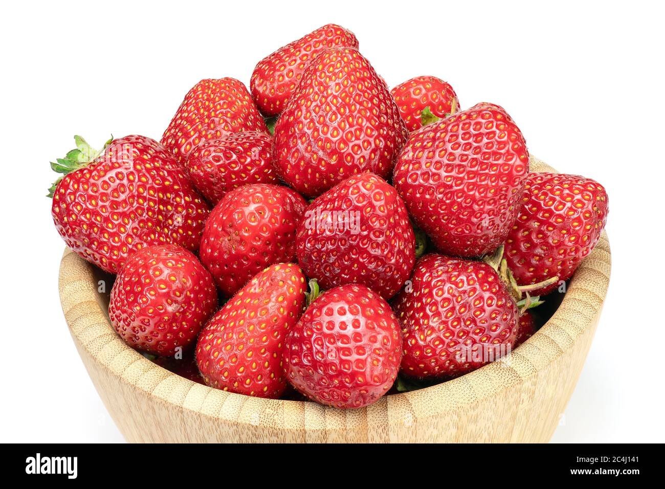 Fresh strawberries in wooden bowl isolated on white background. Full depth of field with clipping path. Stock Photo