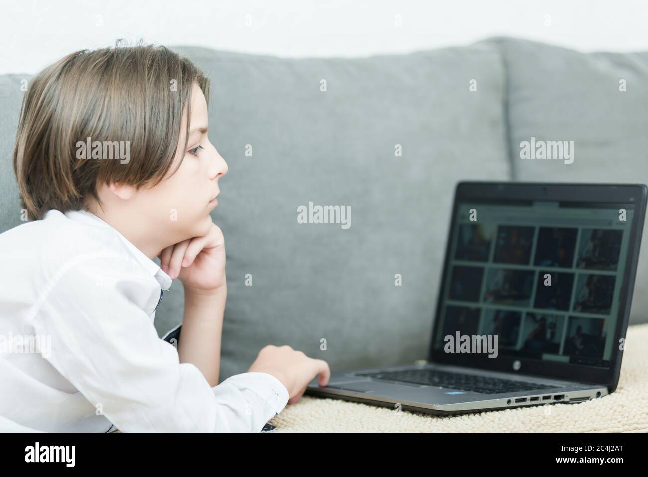 boy in a room with a laptop and a smartphone Stock Photo - Alamy