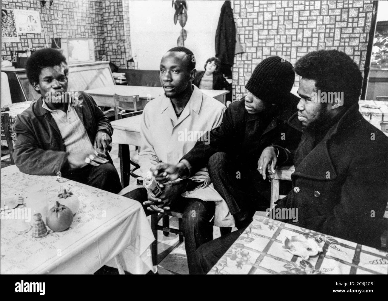 A group of young black men chatting in a cafe in Brixton, London in the early 1970s Stock Photo