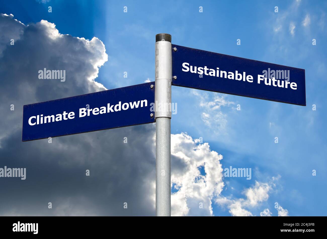 Crossroads sign symbolizing choice between climate breakdown and a sustainable future Stock Photo
