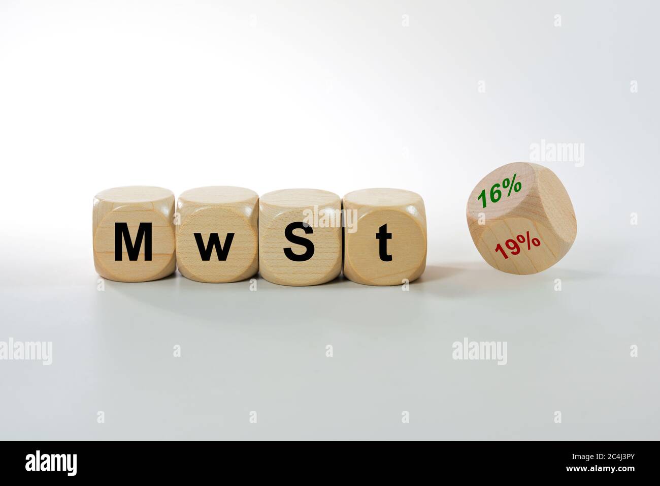 German economic stimulus package after the corona crisis lowers costs, MwSt (value added tax) written on wooden cubes, one dice turns from 19% to 16%, Stock Photo