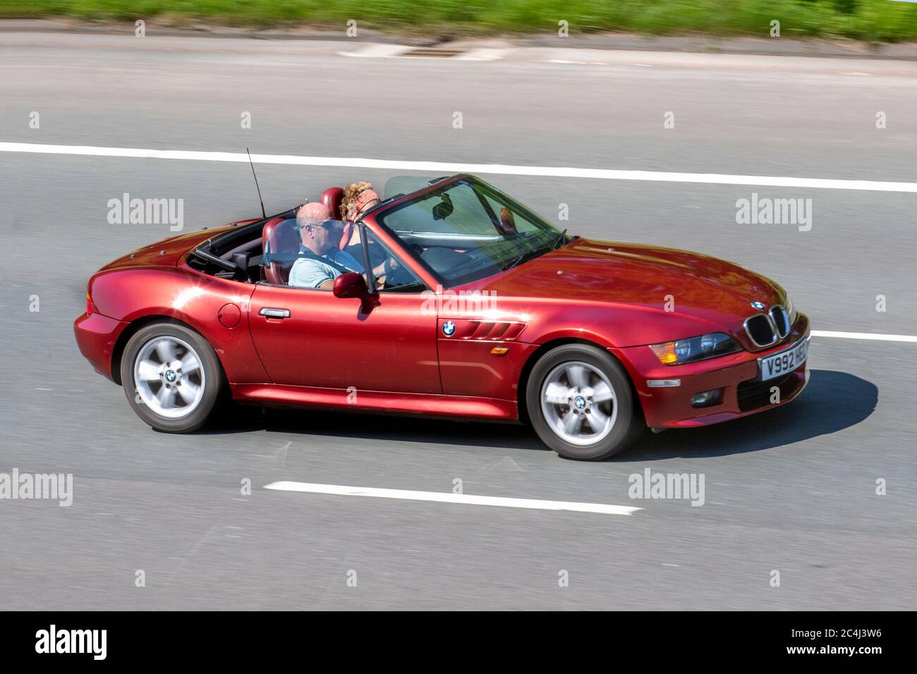 1999 90s red BMW Z3; Vehicular traffic moving vehicles, cars driving vehicle on UK roads, motors, motoring on the M6 motorway highway network. Stock Photo