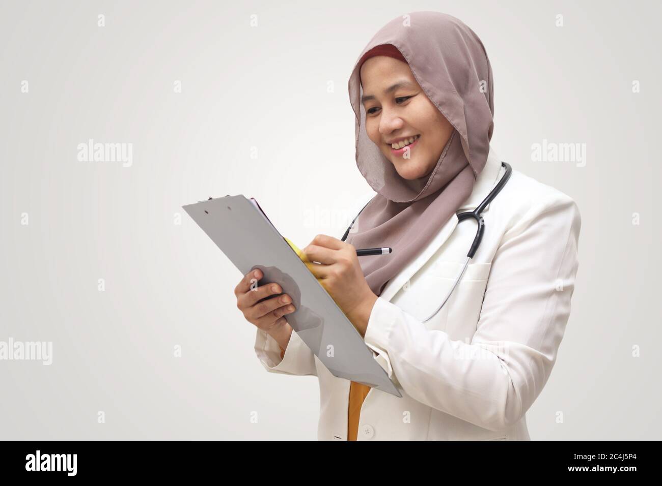 Asian muslim female doctor wearing hijab with stethoscope in white coat