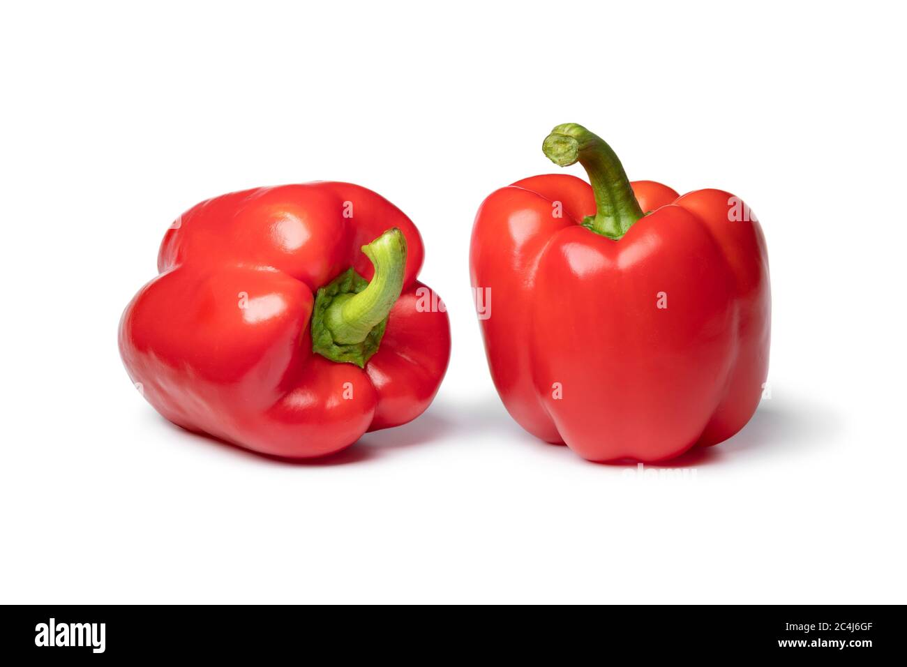 Pair of fresh red bell peppers close up isolated on white background Stock Photo