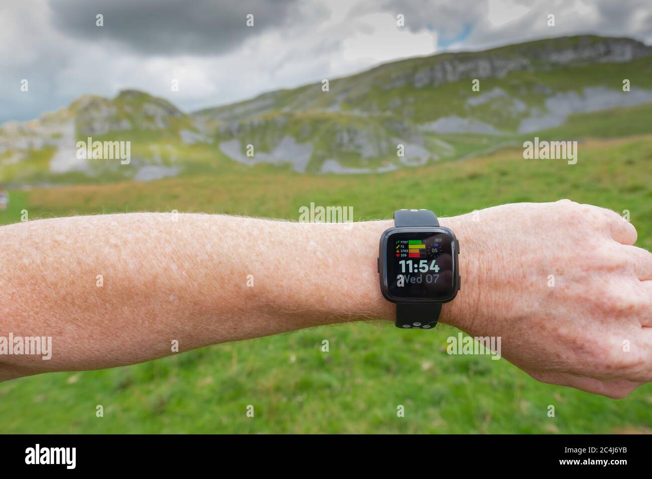 Adult male seen wearing a popular fitness tracker on his left wrist