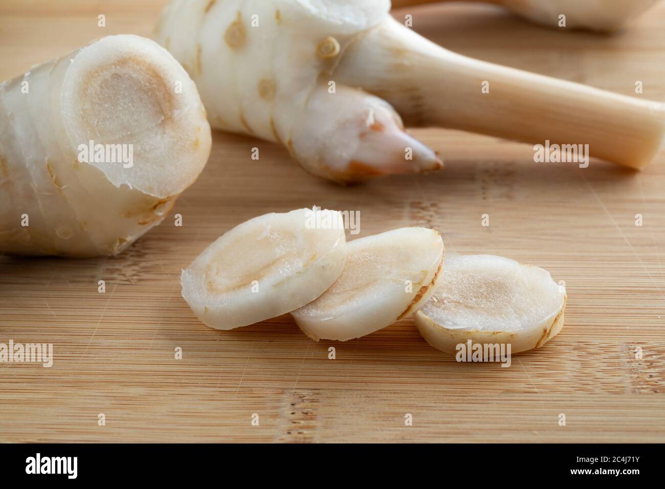 Fresh piece and slices of raw juicy Galangal rhizome close up Stock Photo