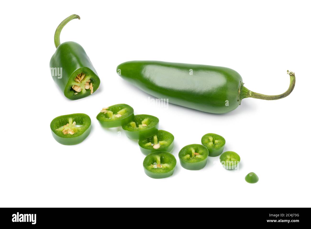 Fresh green jalapeno peppers and slices isolated on white background