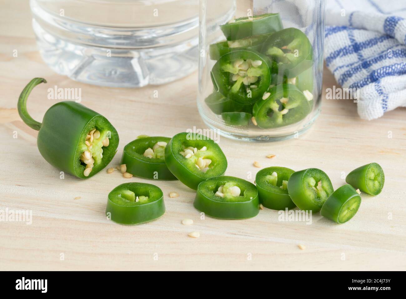 Fresh green jalapeno peppers cut into slices to pickle in vinegar Stock Photo