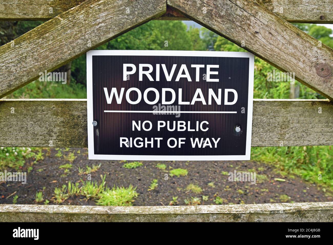 Sign for private woodland no public right of way in Scotland. This is not enforceable due to the right to roam in Scotland. Stock Photo