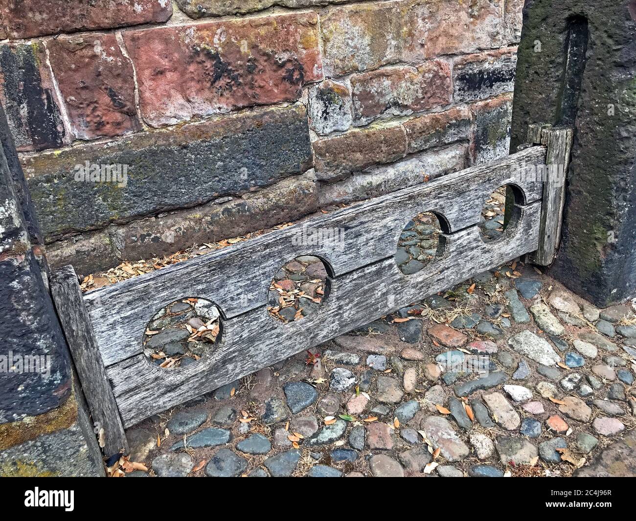 Great Budworth village stocks, punishment restraining device for feet, Northwich,Cheshire, North West England, UK - corporal punishment Stock Photo