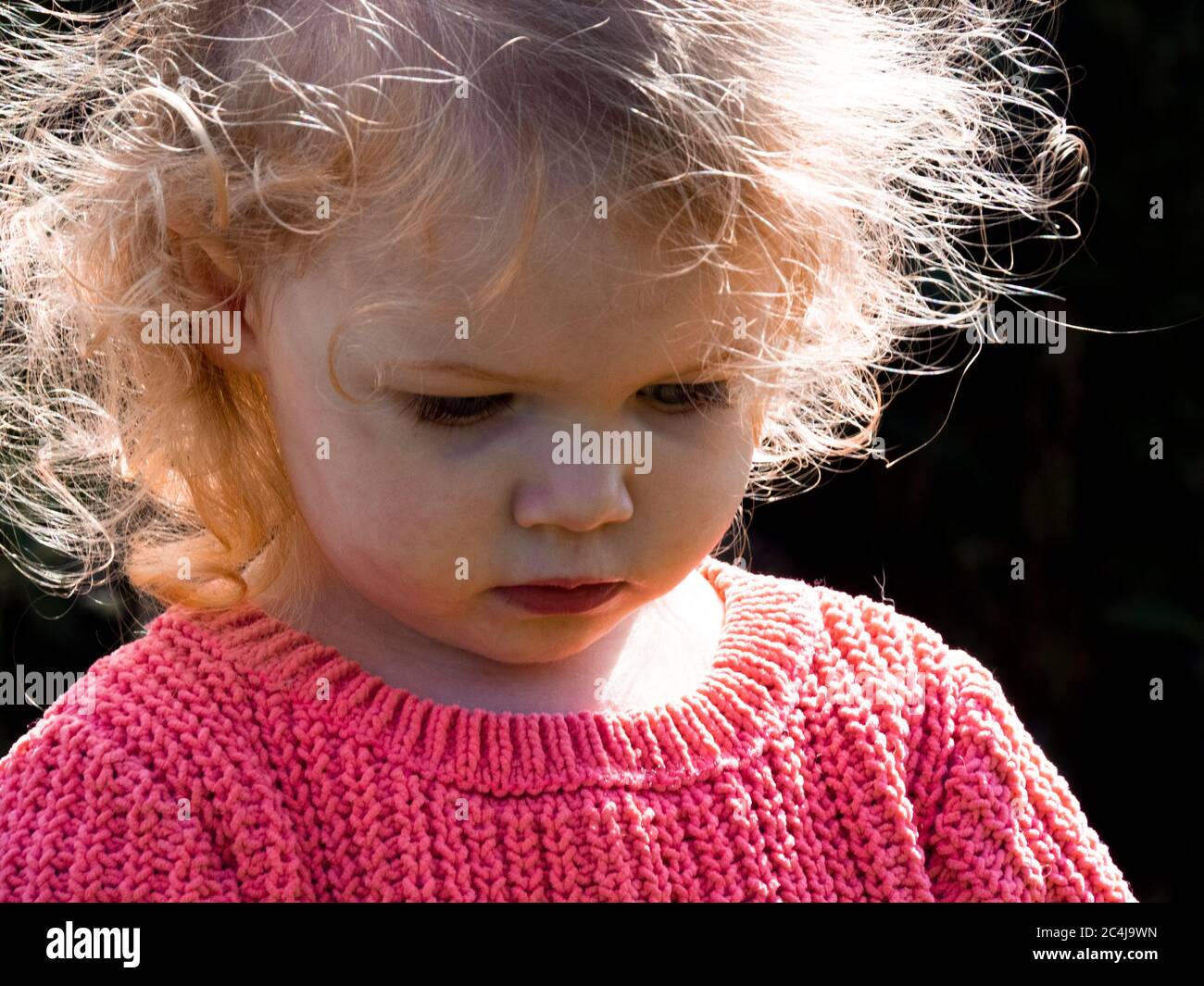 Close up of a toddler looking down, UK Stock Photo