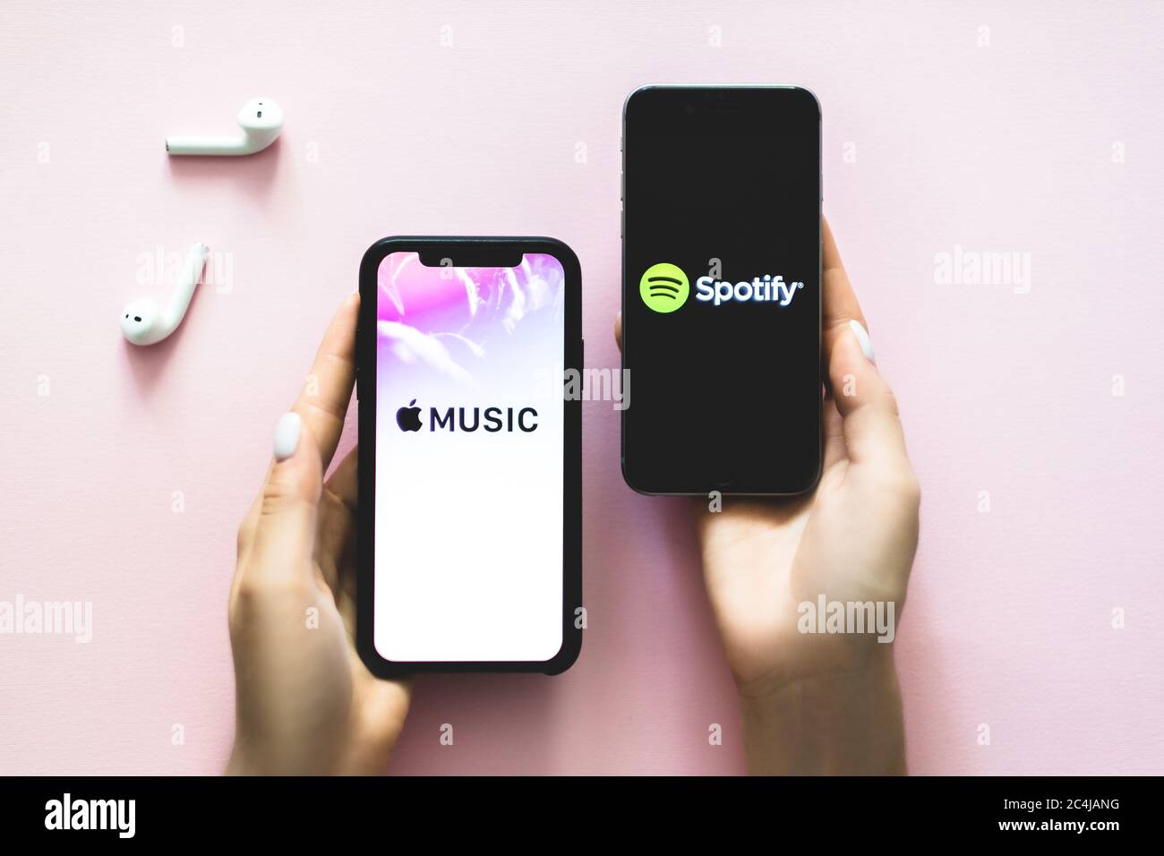 hands holding iPhone X with Screen shot of Apple music app and Spotify  Stock Photo - Alamy