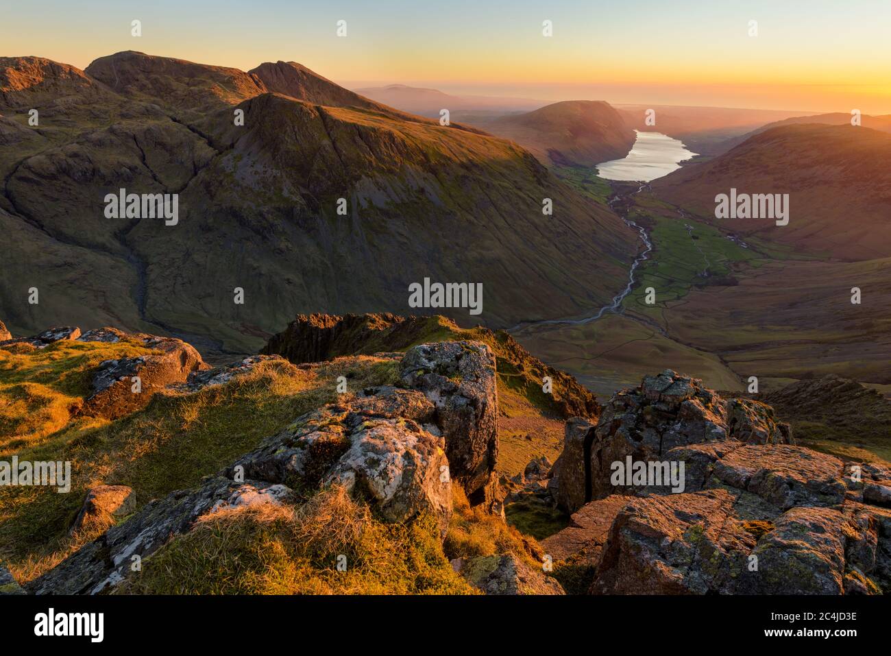 Beautiful Sunset High Up In Mountains With Wastwater Lake In Distance, Lake District, UK. Stock Photo