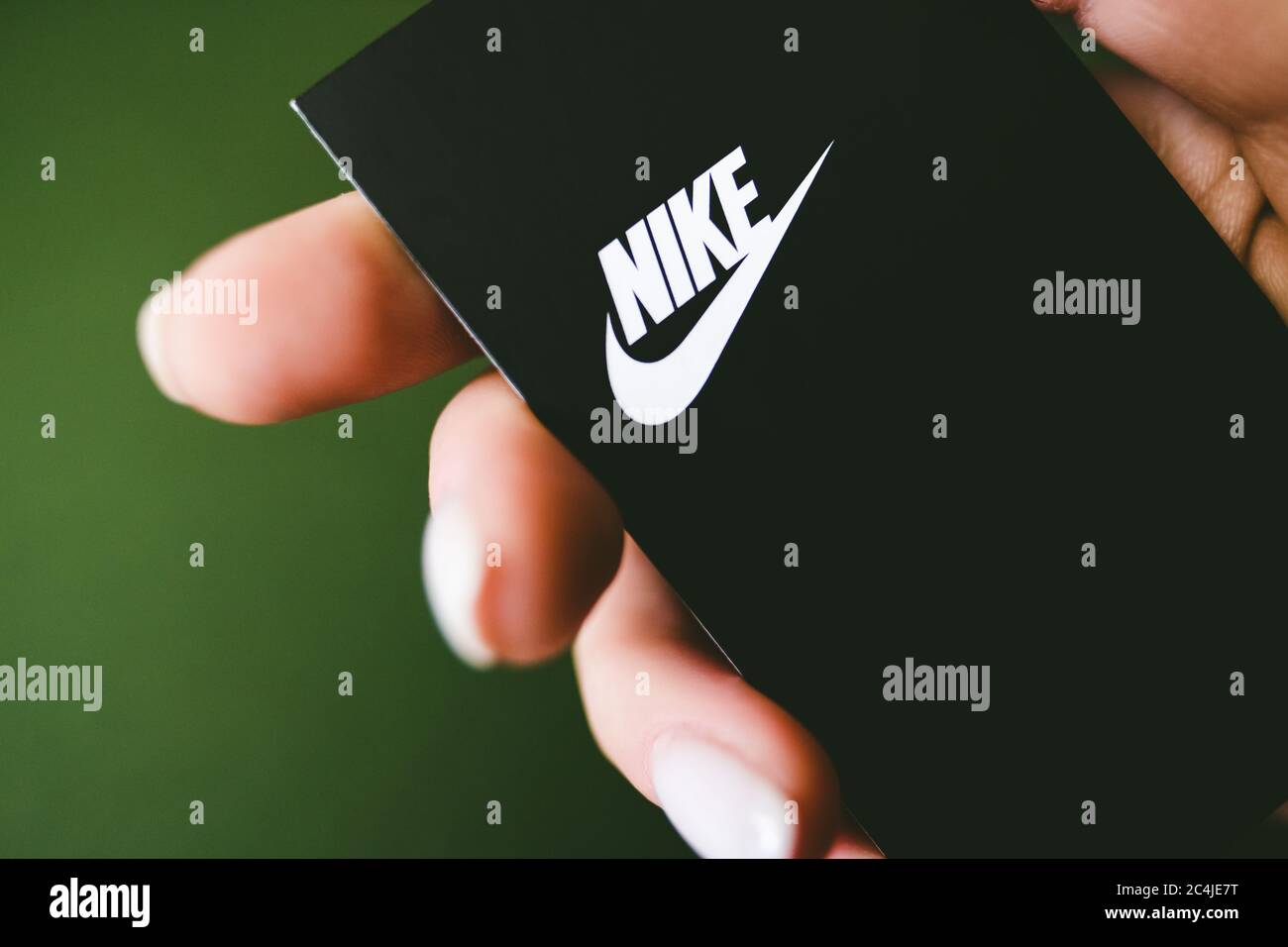 Closeup of Nike logo label on green background Stock Photo - Alamy