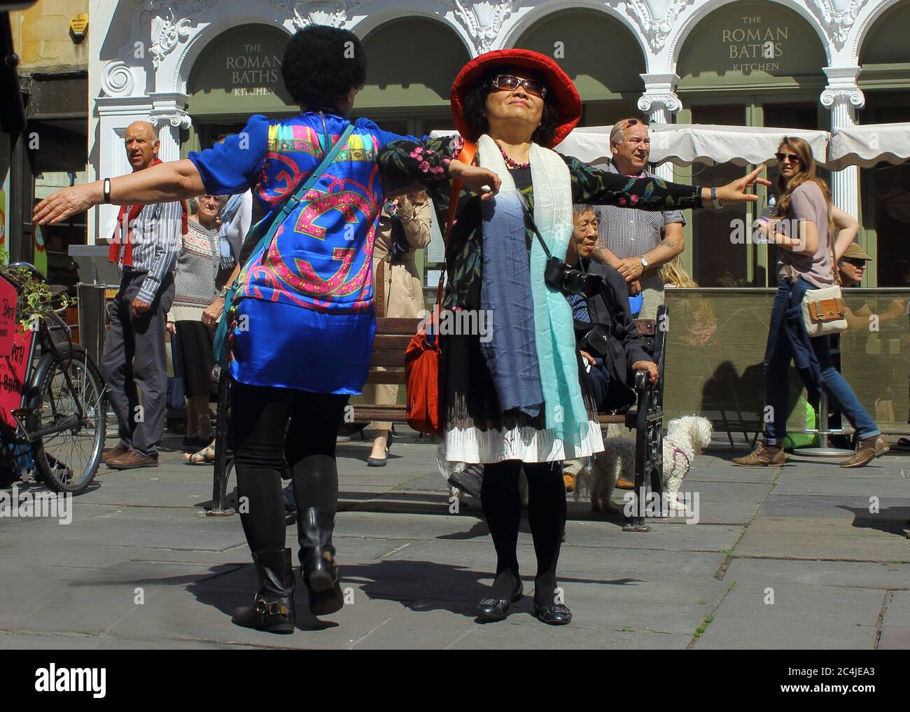 Chinese tourists are dancing in front of Roman Bath in Bath, England. The photo was taken on 5th June, 2015 Stock Photo