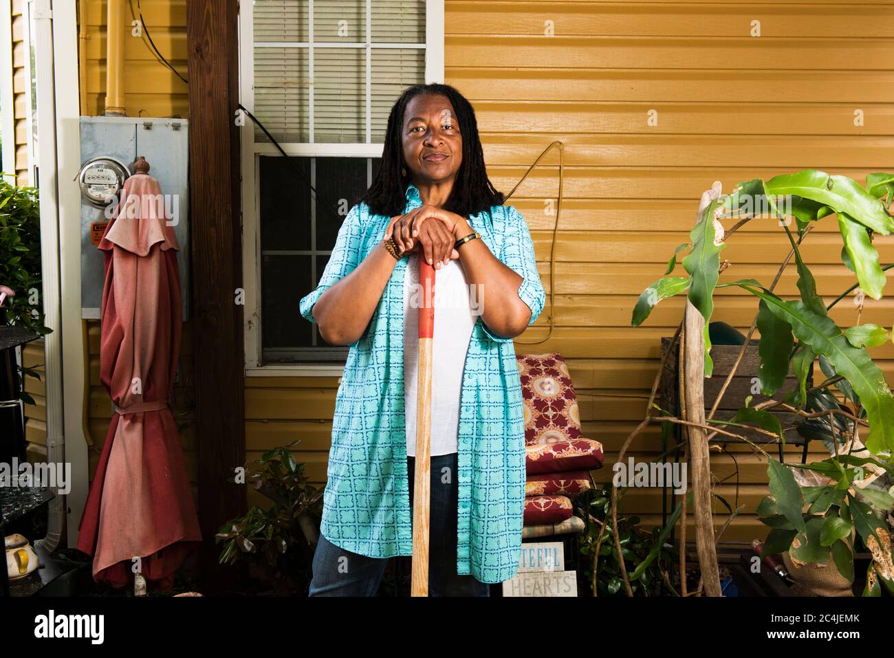 Portrait of African-American woman standing in front of her house Stock ...