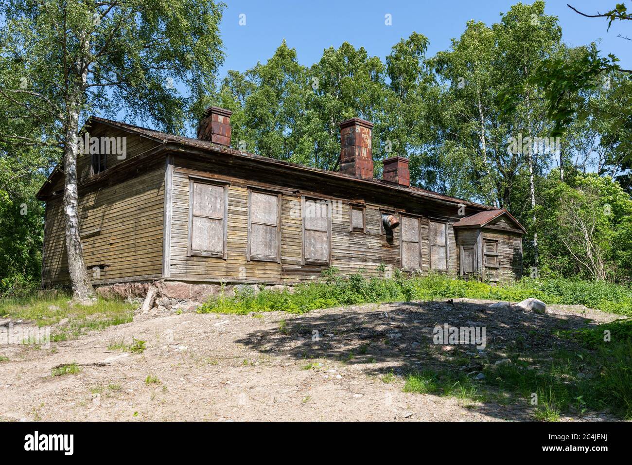 Dilapidated old wooden residential building in Vallisaari, former military island, now a day trip destination in archipelago of Helsinki, Finland Stock Photo