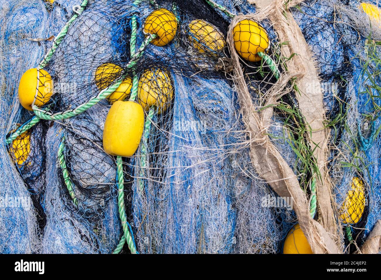 Fishing nets still life background pattern. Fishermen tackle, ropes and  fishnets, piled on a wharf. Close up texture. Fresh fish from the sea Stock  Photo - Alamy