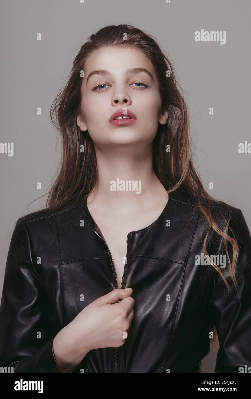 Fashion portrait of a young woman wearing leather jacket Stock Photo ...