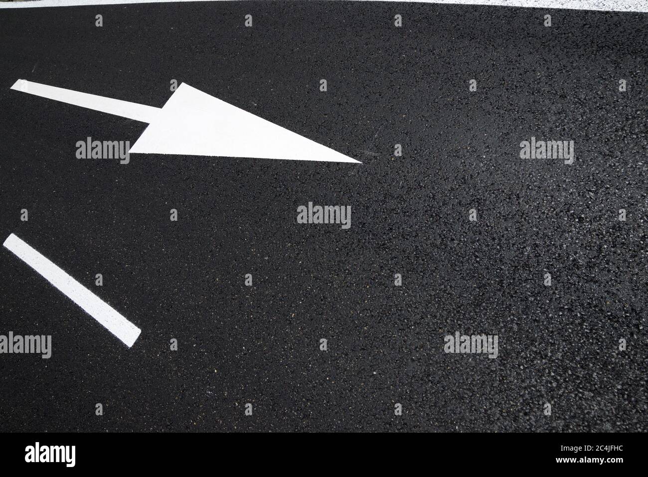 Arrow directional signal painted on the floor in Spain Stock Photo - Alamy
