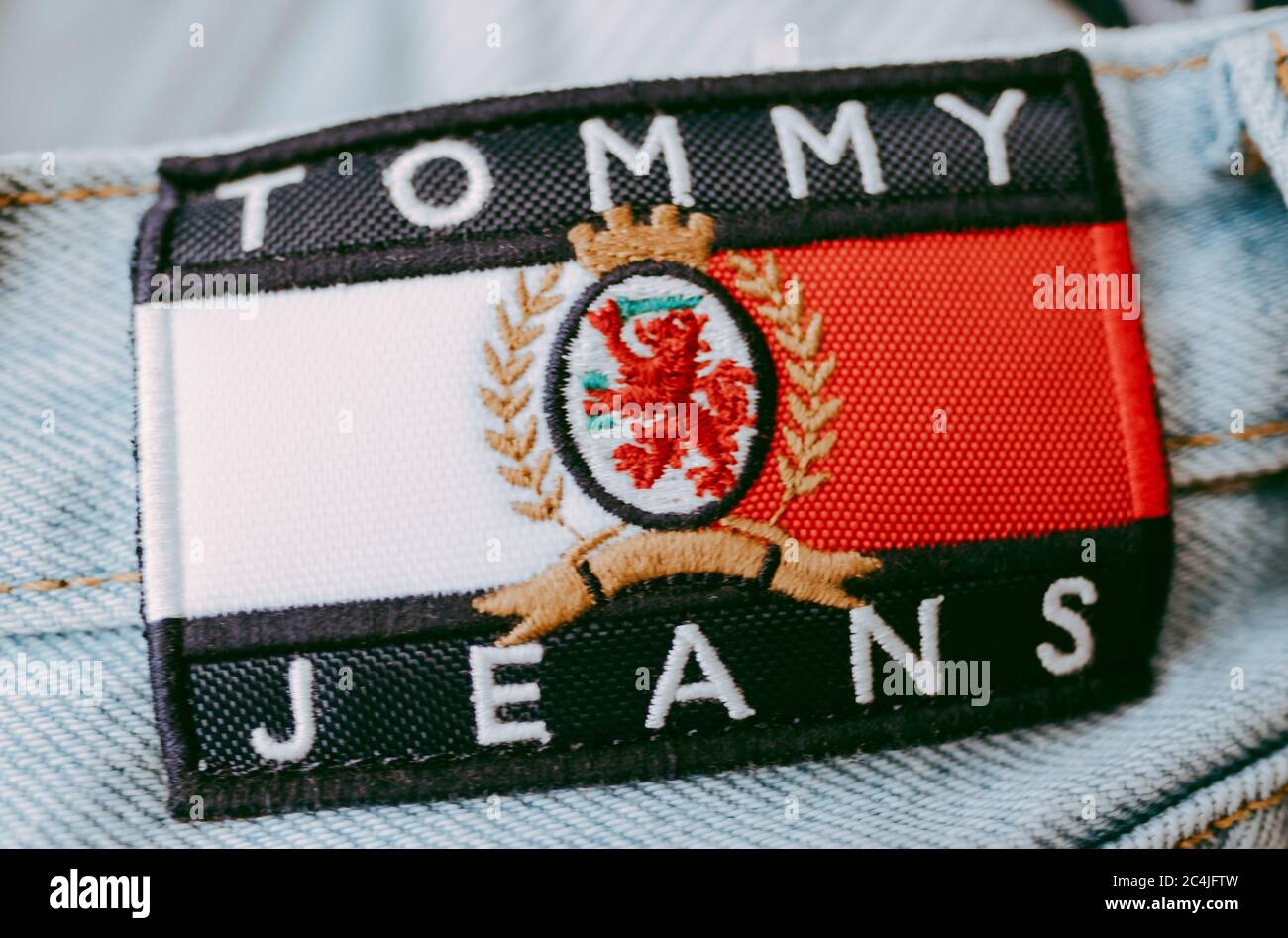 Closeup of Tommy Hilfiger label on blue jeans Stock Photo - Alamy