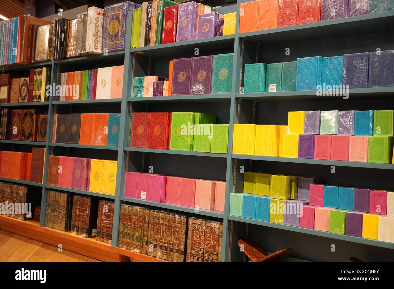 Stack of Quran on the shelf. Quran religious book stacked in shelf for sale. Available in Various languages in a book store. Islamic books for sale, A Stock Photo
