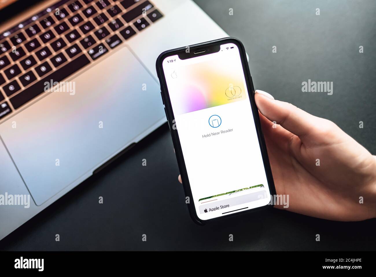 Womans hand holding the iPhone X with Apple Card on the screen Stock ...