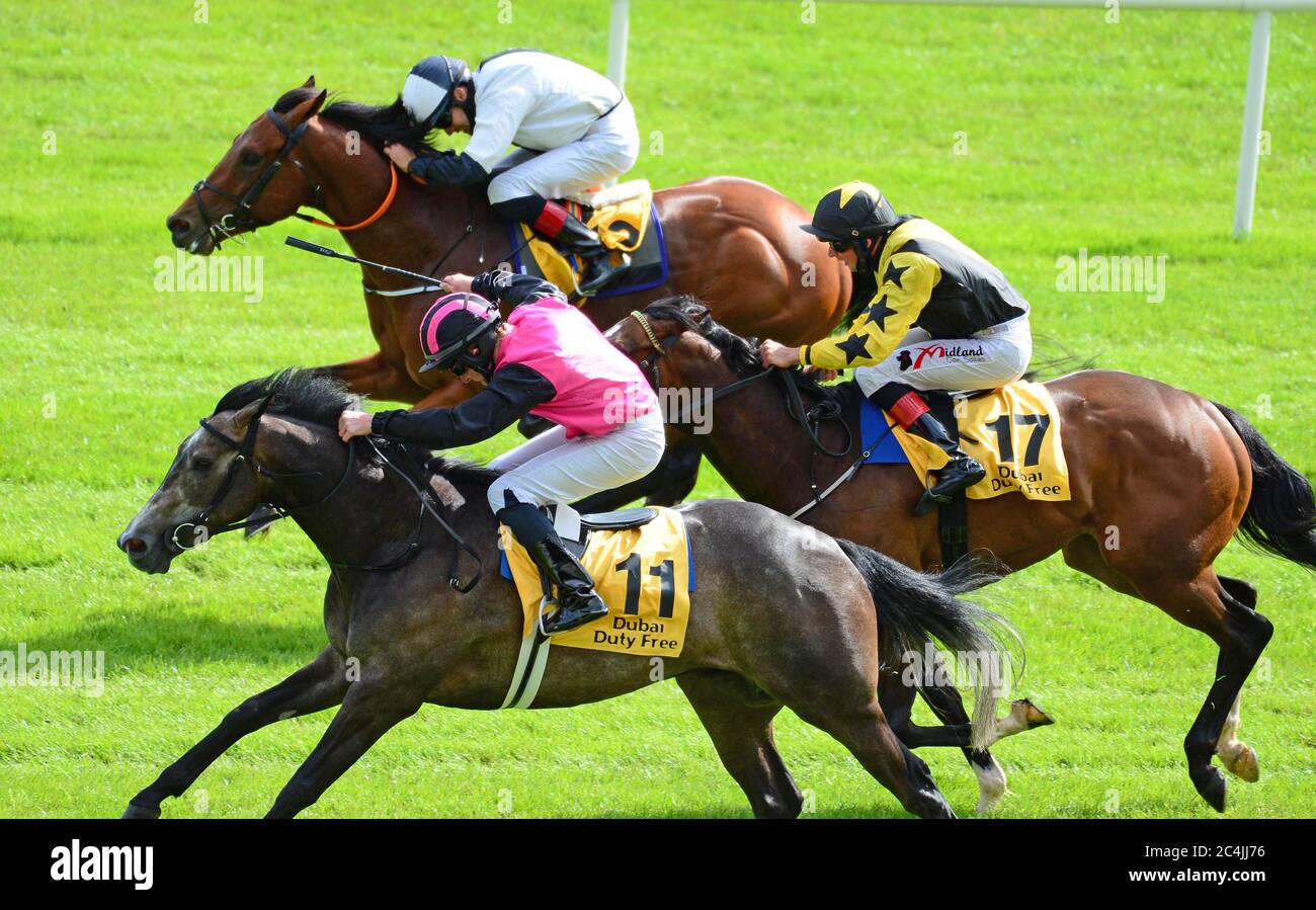 Big Gossey ridden by Michael Hussey (pink and black silks) wins the Dubai Duty Free Tennis Championships Handicap at Curragh Racecourse. Stock Photo