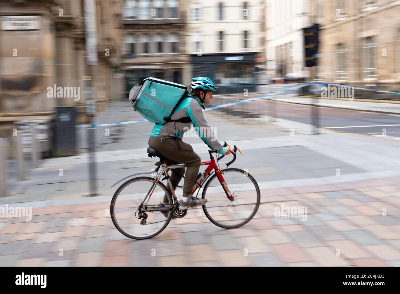 Deliveroo takeaway food delivery couriers on cycles in Glasgow city